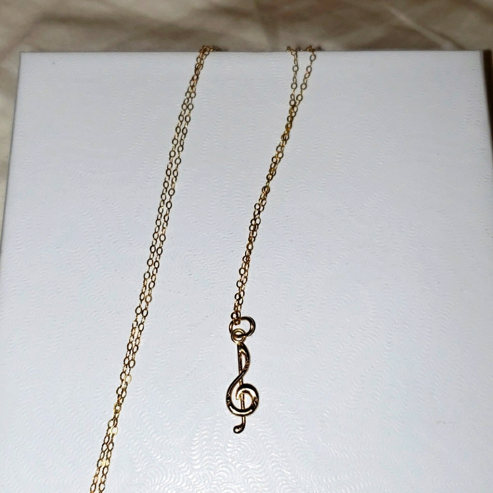 Gold treble clef necklace